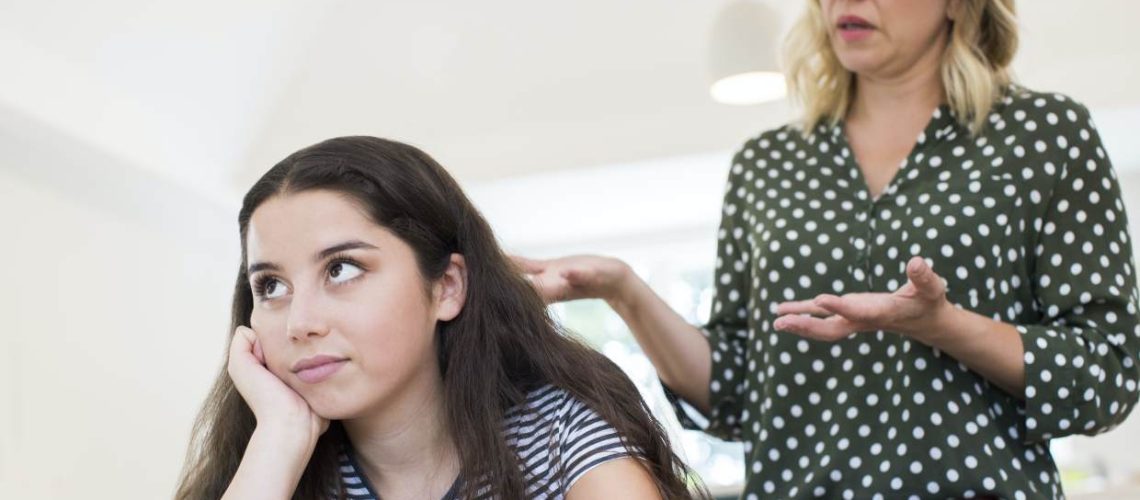 Mother Arguing With Teenage Daughter Over Use Of Mobile Phone